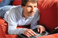 Man with Laptop on Couch