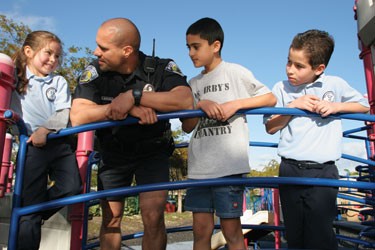 Officer and Kids on Playground